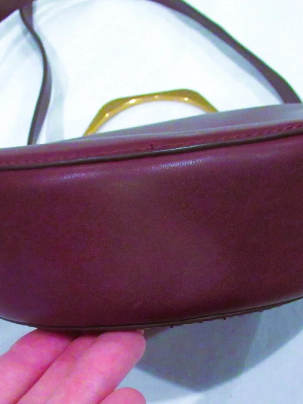 Thacker burgundy purse, both a crossbody and a bracelet handle